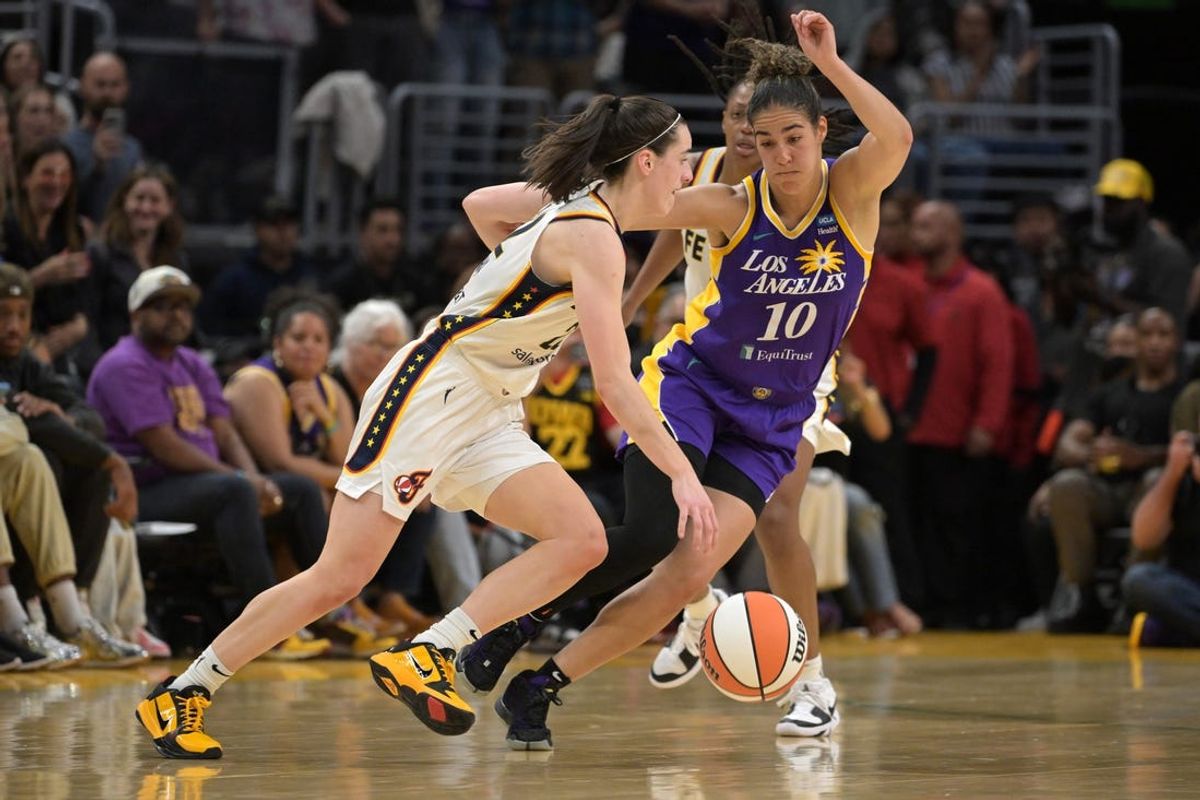 May 24, 2024; Los Angeles, California, USA;  Indiana Fever guard Caitlin Clark (22) is defended by Los Angeles Sparks guard Kia Nurse (10) in the second half at Crypto.com Arena. Mandatory Credit: Jayne Kamin-Oncea-USA TODAY Sports