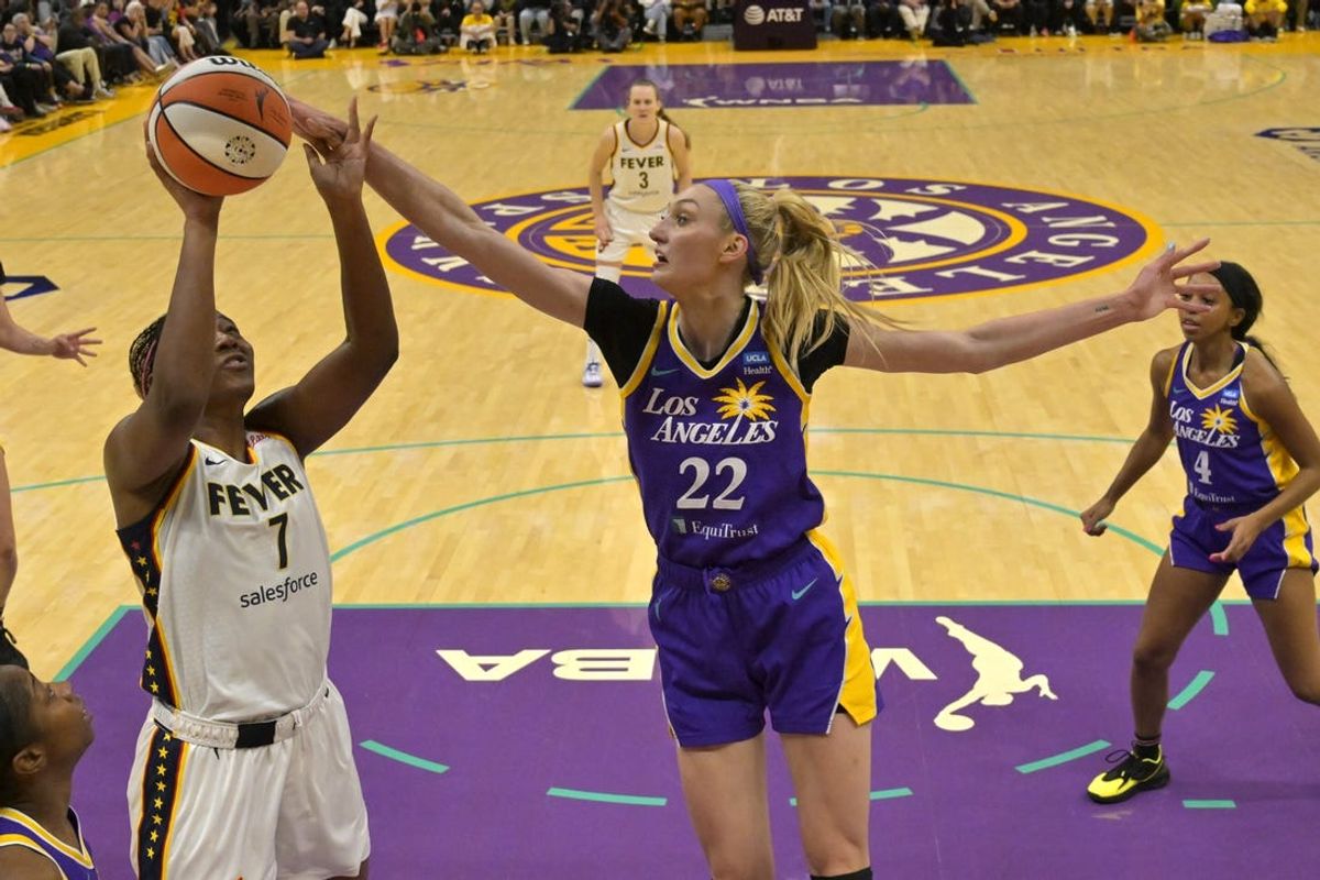 May 24, 2024; Los Angeles, California, USA;  Los Angeles Sparks forward Cameron Brink (22) blocks a shot by Indiana Fever forward Aliyah Boston (7) in the first half at Crypto.com Arena. Mandatory Credit: Jayne Kamin-Oncea-USA TODAY Sports