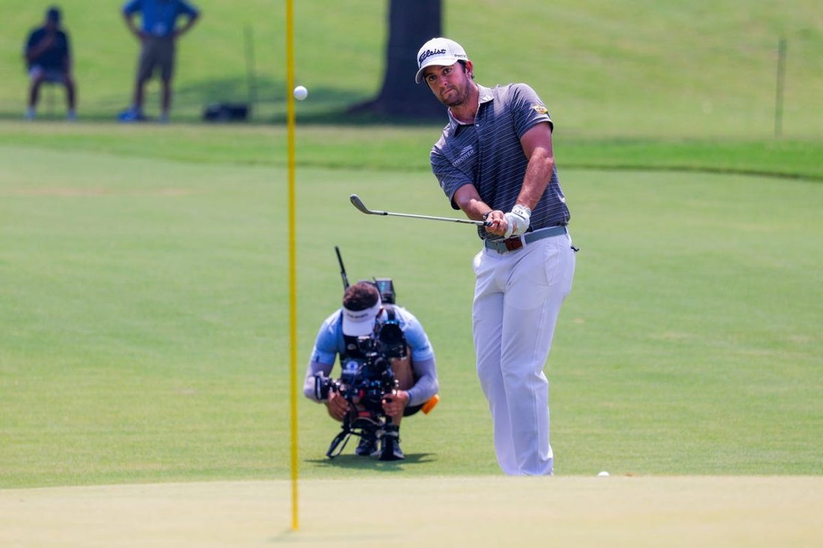 May 25, 2024; Fort Worth, Texas, USA; Davis Riley chips on to the 11th green during the third round of the Charles Schwab Challenge golf tournament. Mandatory Credit: Andrew Dieb-USA TODAY Sports
