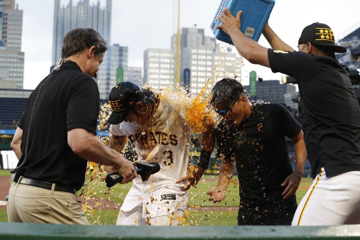 May 25, 2024; Pittsburgh, Pennsylvania, USA;  Pittsburgh Pirates pitcher Martín Perez (right) dumps Powerade on center fielder Ji Hwan Bae (3) after the Pirates defeated the Atlanta Braves at PNC Park. Pittsburgh won 4-1.  Mandatory Credit: Charles LeClaire-USA TODAY Sports
