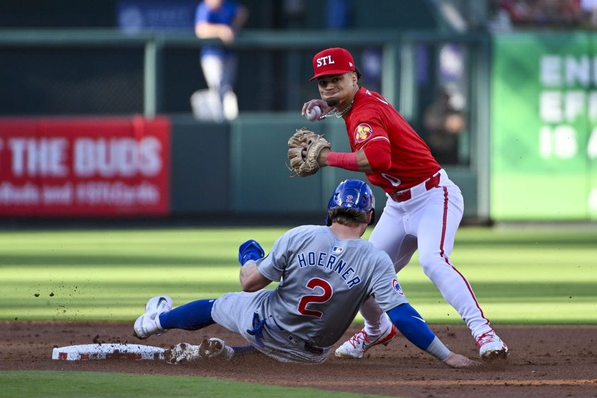 May 25, 2024; St. Louis, Missouri, USA;  St. Louis Cardinals shortstop Masyn Winn (0) forces out Chicago Cubs second baseman Nico Hoerner (2) and throws to first to complete the double play during the second inning at Busch Stadium. Mandatory Credit: Jeff Curry-USA TODAY Sports