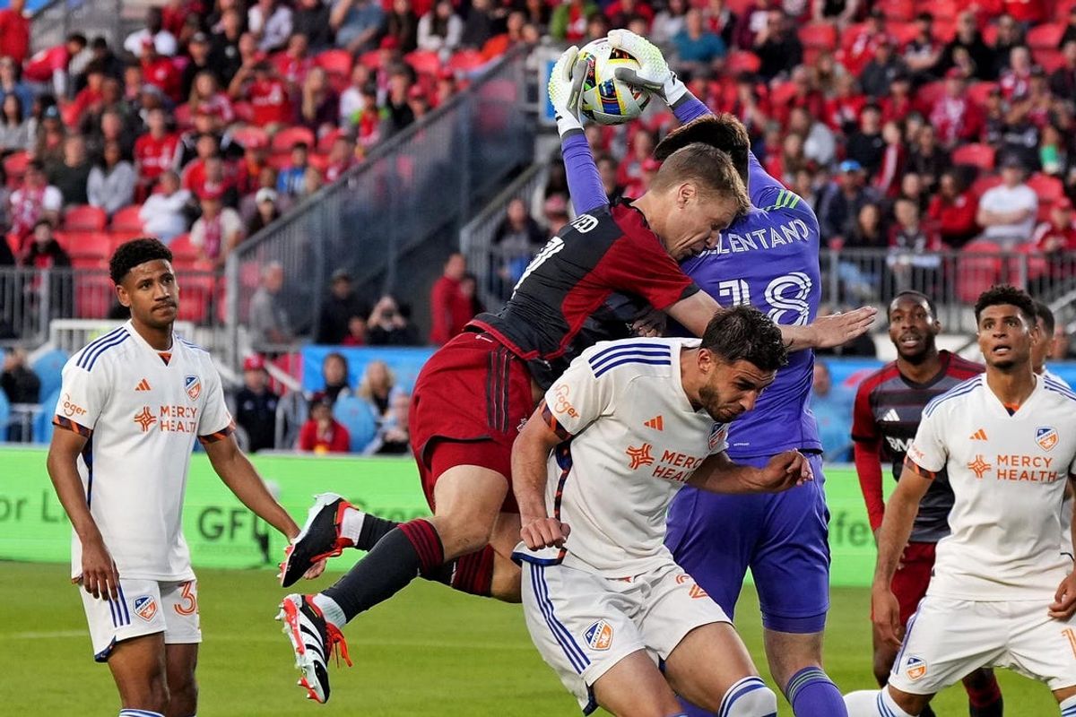 May 25, 2024; Toronto, Ontario, CAN; Toronto FC defender Sigurd Rosted (17) collides with FC Cincinnati goalkeeper Roman Celentano (18) during the first half at BMO Field. Mandatory Credit: Nick Turchiaro-USA TODAY Sports