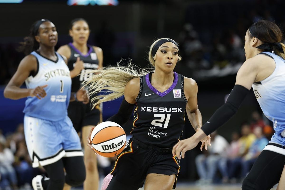 May 25, 2024; Chicago, Illinois, USA; Connecticut Sun guard DiJonai Carrington (21) drives to the basket against the Chicago Sky during the first half of a WNBA game at Wintrust Arena. Mandatory Credit: Kamil Krzaczynski-USA TODAY Sports