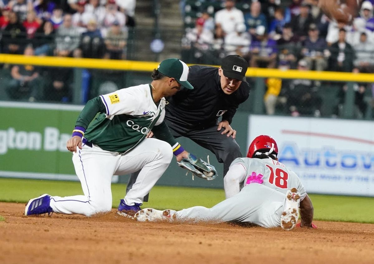 May 25, 2024; Denver, Colorado, USA;  Philadelphia Phillies outfielder Johan Rojas (18) safely steals second base at Coors Field. Mandatory Credit: Michael Madrid-USA TODAY Sports