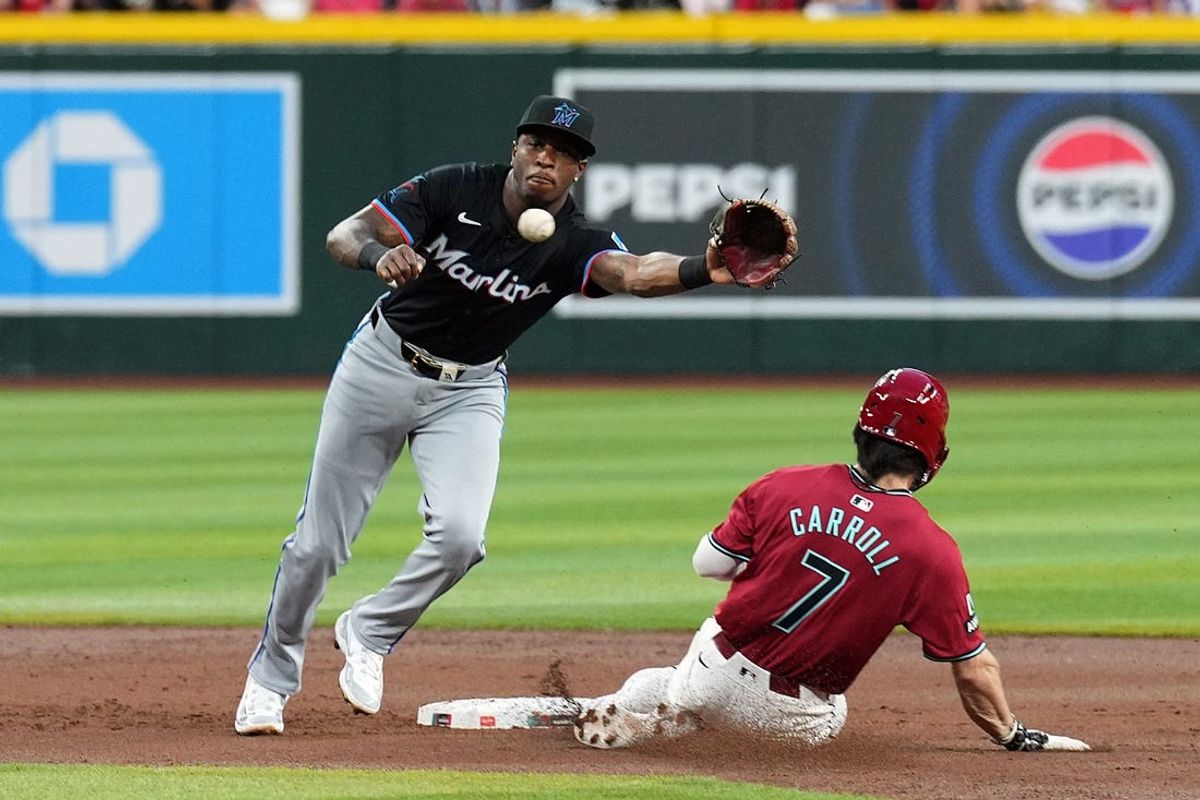 May 25, 2024; Phoenix, Arizona, USA; Arizona Diamondbacks outfielder Corbin Carroll (7) beats a throw to Miami Marlins shortstop Tim Anderson (7) to steal second base during the first inning at Chase Field. Mandatory Credit: Joe Camporeale-USA TODAY Sports