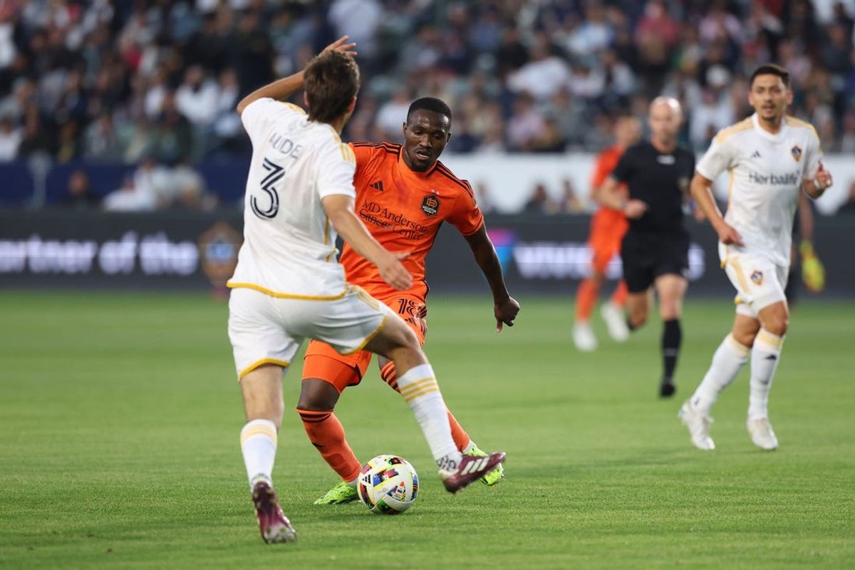 May 25, 2024; Carson, California, USA; Houston Dynamo FC forward Ibrahim Aliyu (18) battle for the ball against LA Galaxy defender Julian Aude (3) in the first half at Dignity Health Sports Park. Mandatory Credit: Kiyoshi Mio-USA TODAY Sports