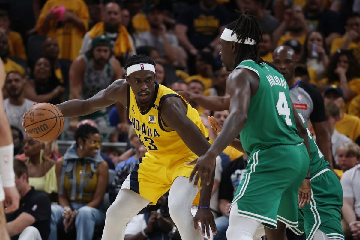 May 25, 2024; Indianapolis, Indiana, USA; Indiana Pacers forward Pascal Siakam (43) controls the ball against Boston Celtics guard Jrue Holiday (4) during the fourth quarter of game three of the eastern conference finals in the 2024 NBA playoffs at Gainbridge Fieldhouse. Mandatory Credit: Trevor Ruszkowski-USA TODAY Sports