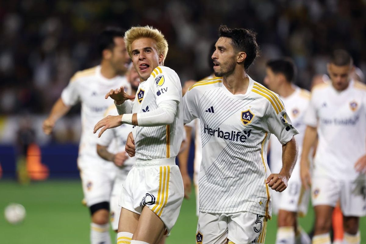 May 25, 2024; Carson, California, USA; LA Galaxy midfielder Riqui Puig (10) celebrates with midfielder Gaston Brugman (5) after scoring a goal against Houston Dynamo FC in the second half at Dignity Health Sports Park. Mandatory Credit: Kiyoshi Mio-USA TODAY Sports