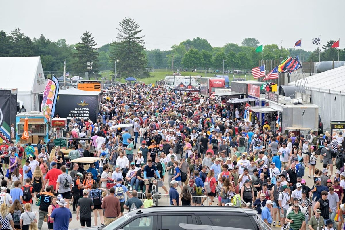 Fans evacuate the grandstands as a storm moves ahead of the 108th running of the Indianapolis 500 at Indianapolis Motor Speedway.