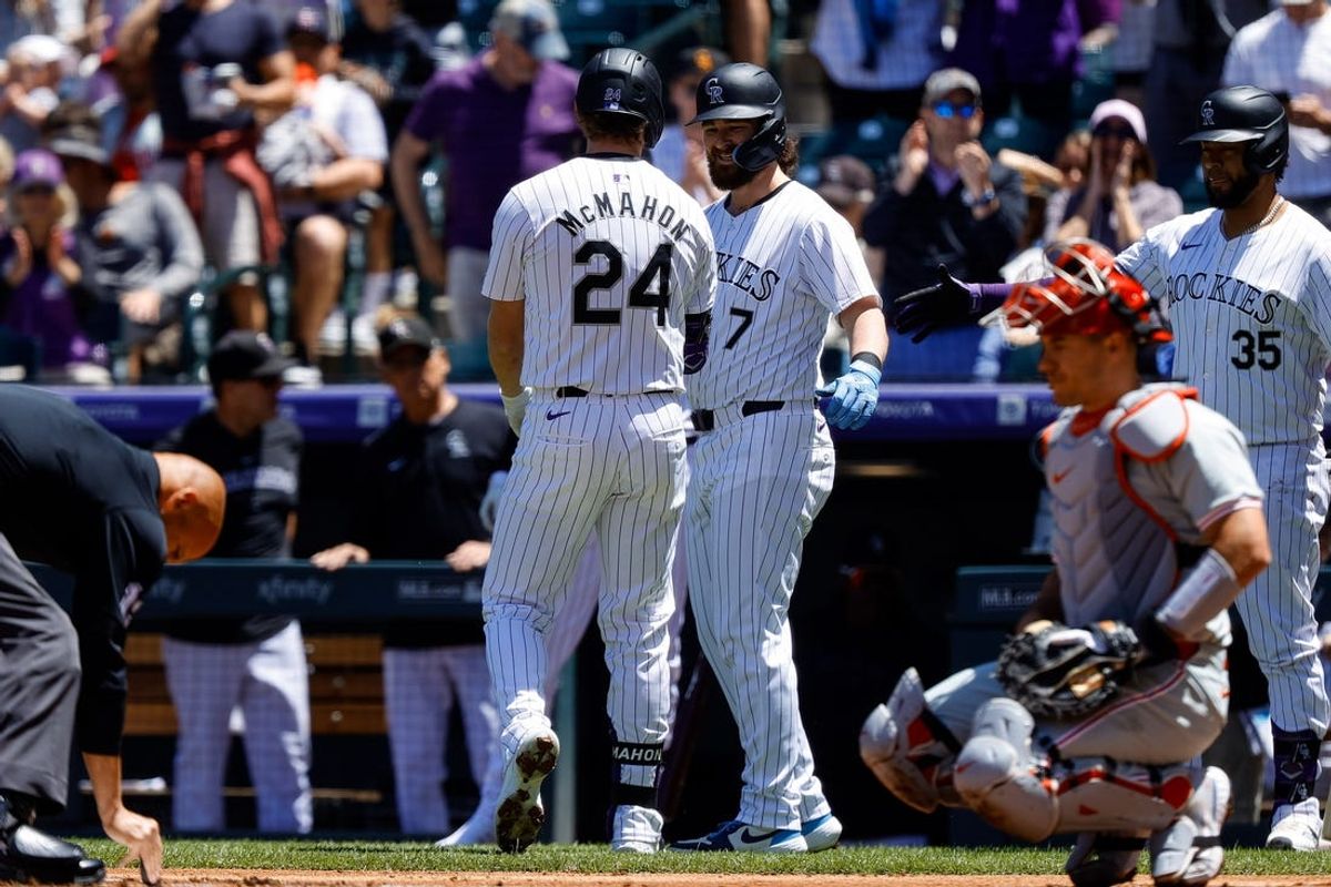 May 26, 2024; Denver, Colorado, USA; Colorado Rockies second baseman Brendan Rodgers (7) celebrates the two run home run of third baseman Ryan McMahon (24) in the first inning against the Philadelphia Phillies at Coors Field. Mandatory Credit: Isaiah J. Downing-USA TODAY Sports