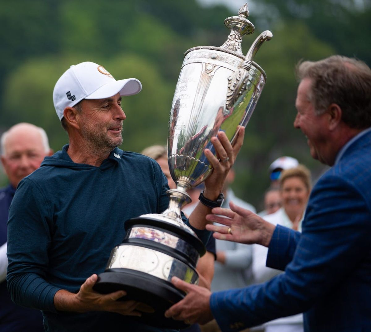 Richard Bland, left, accepts his trophy for winning the 2024 KitchenAid Senior PGA Championship at Harbor Shores Golf Club on Sunday, May 26, 2024, in Benton Harbor, MI.