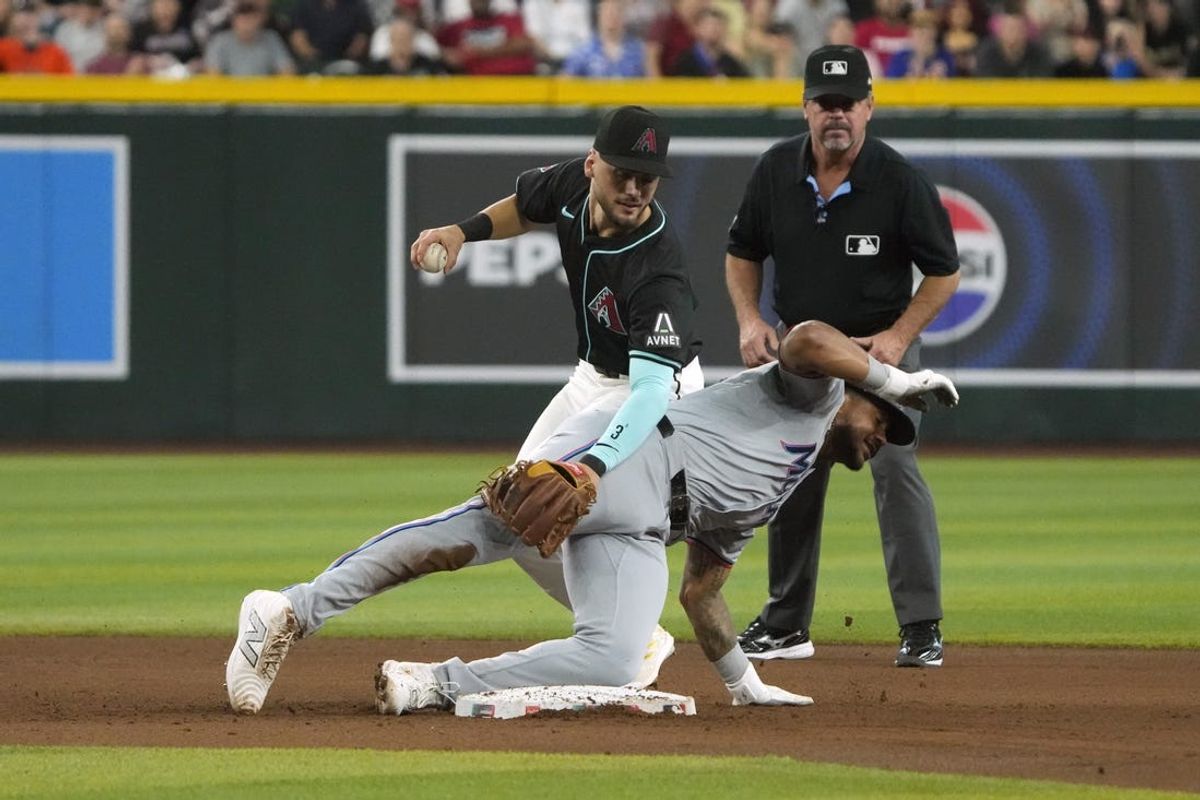 May 26, 2024; Phoenix, Arizona, USA; Arizona Diamondbacks shortstop Blaze Alexander (9) gets the force out on Miami Marlins outfielder Dane Myers (54) in the fifth inning at Chase Field. Mandatory Credit: Rick Scuteri-USA TODAY Sports