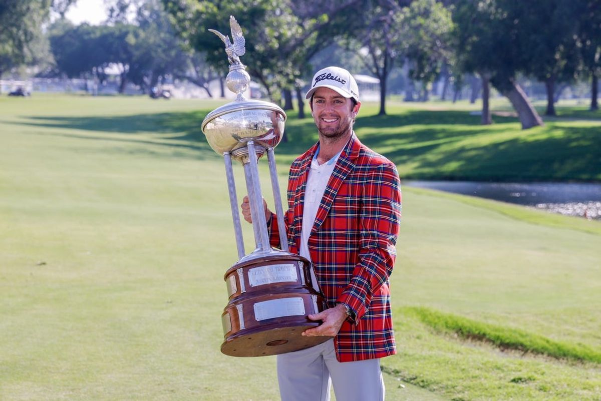 May 26, 2024; Fort Worth, Texas, USA; Davis Riley holds the trophy after winning the Charles Schwab Challenge golf tournament. Mandatory Credit: Andrew Dieb-USA TODAY Sports
