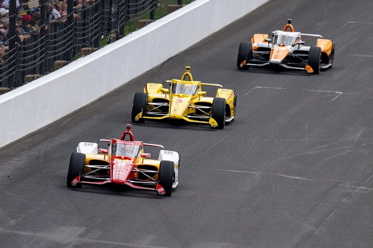 Team Penske driver Josef Newgarden (2) leads a pack of cars into turn one during the 108th running of the Indianapolis 500 Sunday, May 26, 2024 after it was delayed due to weather.
