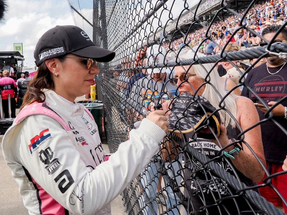 Katherine Legge signs autographs on May 26, 2024 during the 108th running of the Indianapolis 500 at Indianapolis Motor Speedway.