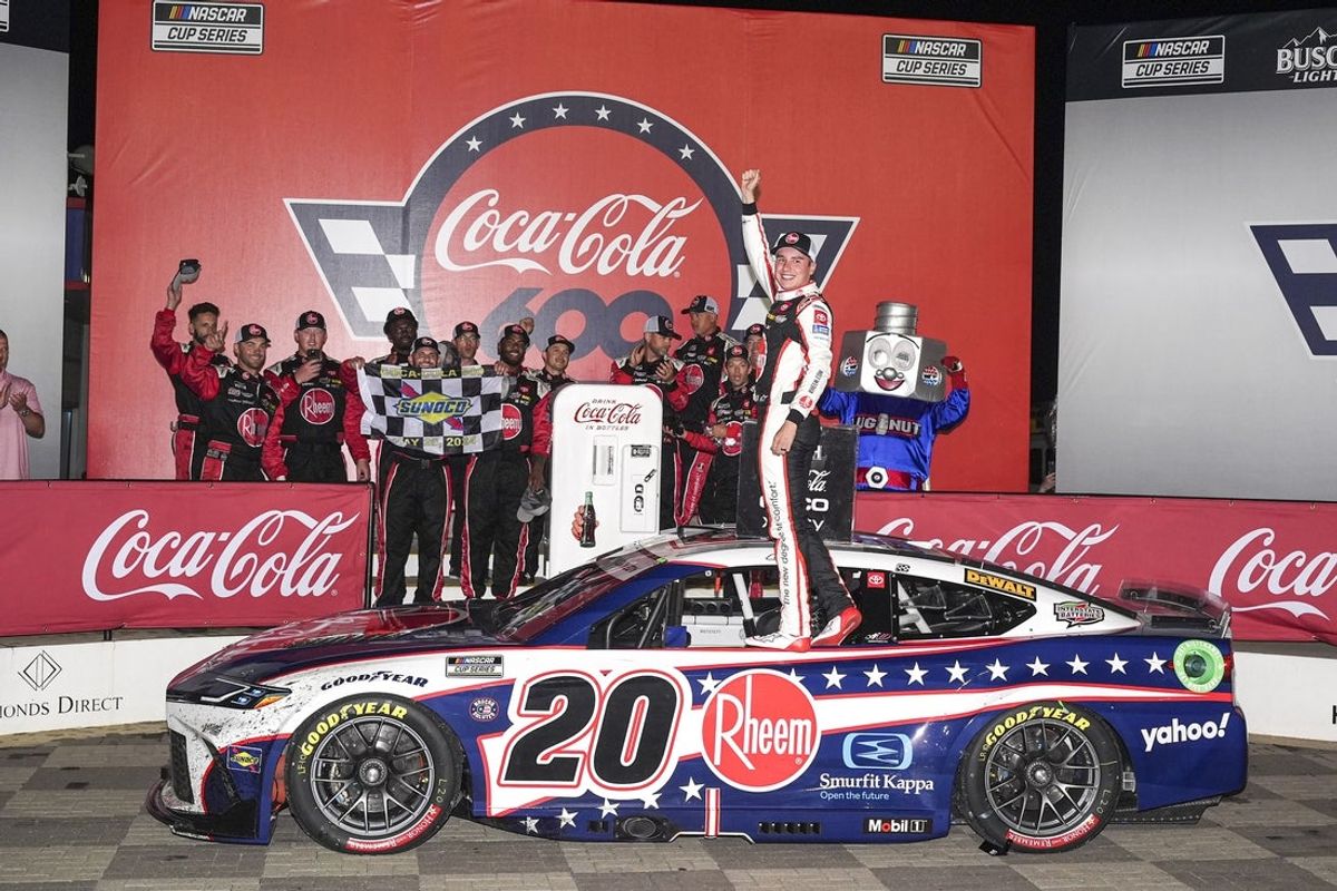 May 26, 2024; Concord, North Carolina, USA;  NASCAR Cup Series driver Christopher Bell (20) is awarded the win in the rain shortened Coca Cola 600 at Charlotte Motor Speedway. Mandatory Credit: Jim Dedmon-Imagn Images