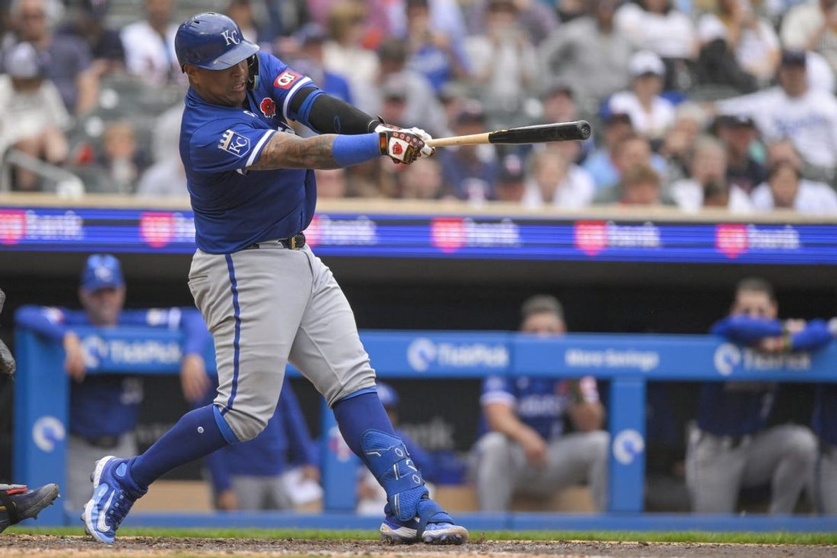 May 27, 2024; Minneapolis, Minnesota, USA; Kansas City Royals catcher Salvador Perez (13) hits a single against the Minnesota Twins during the ninth inning at Target Field. Mandatory Credit: Nick Wosika-USA TODAY Sports