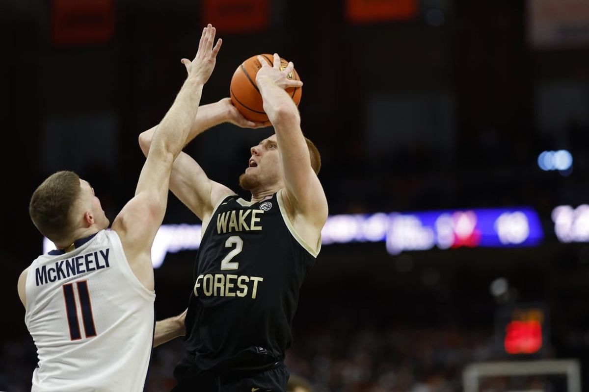 Feb 17, 2024; Charlottesville, Virginia, USA; Wake Forest Demon Deacons guard Cameron Hildreth (2) shoots the ball as Virginia Cavaliers guard Isaac McKneely (11) defends in the first half at John Paul Jones Arena.