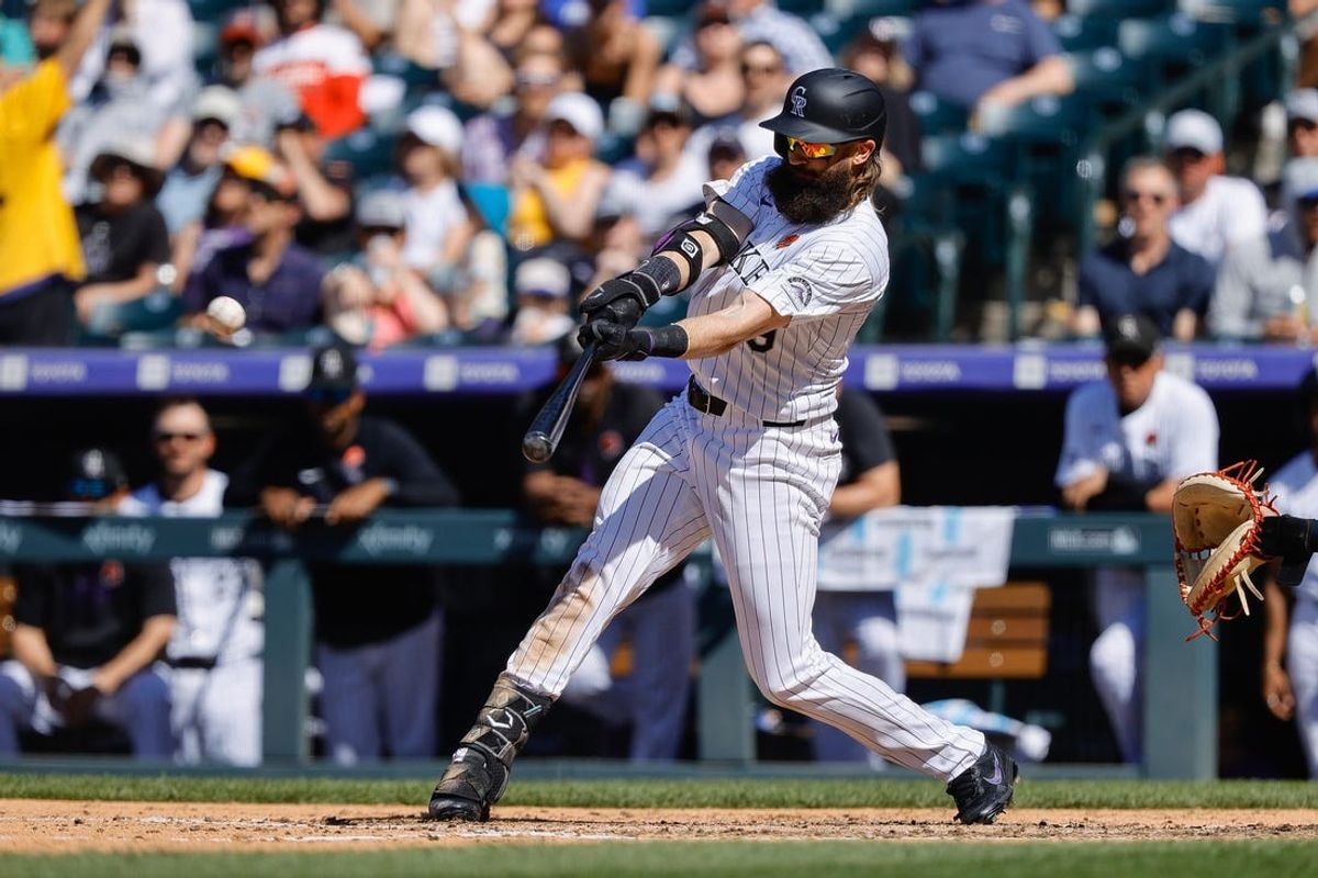 May 27, 2024; Denver, Colorado, USA; Colorado Rockies right fielder Charlie Blackmon (19) hits an RBI double in the sixth inning against the Cleveland Guardians at Coors Field. Mandatory Credit: Isaiah J. Downing-USA TODAY Sports