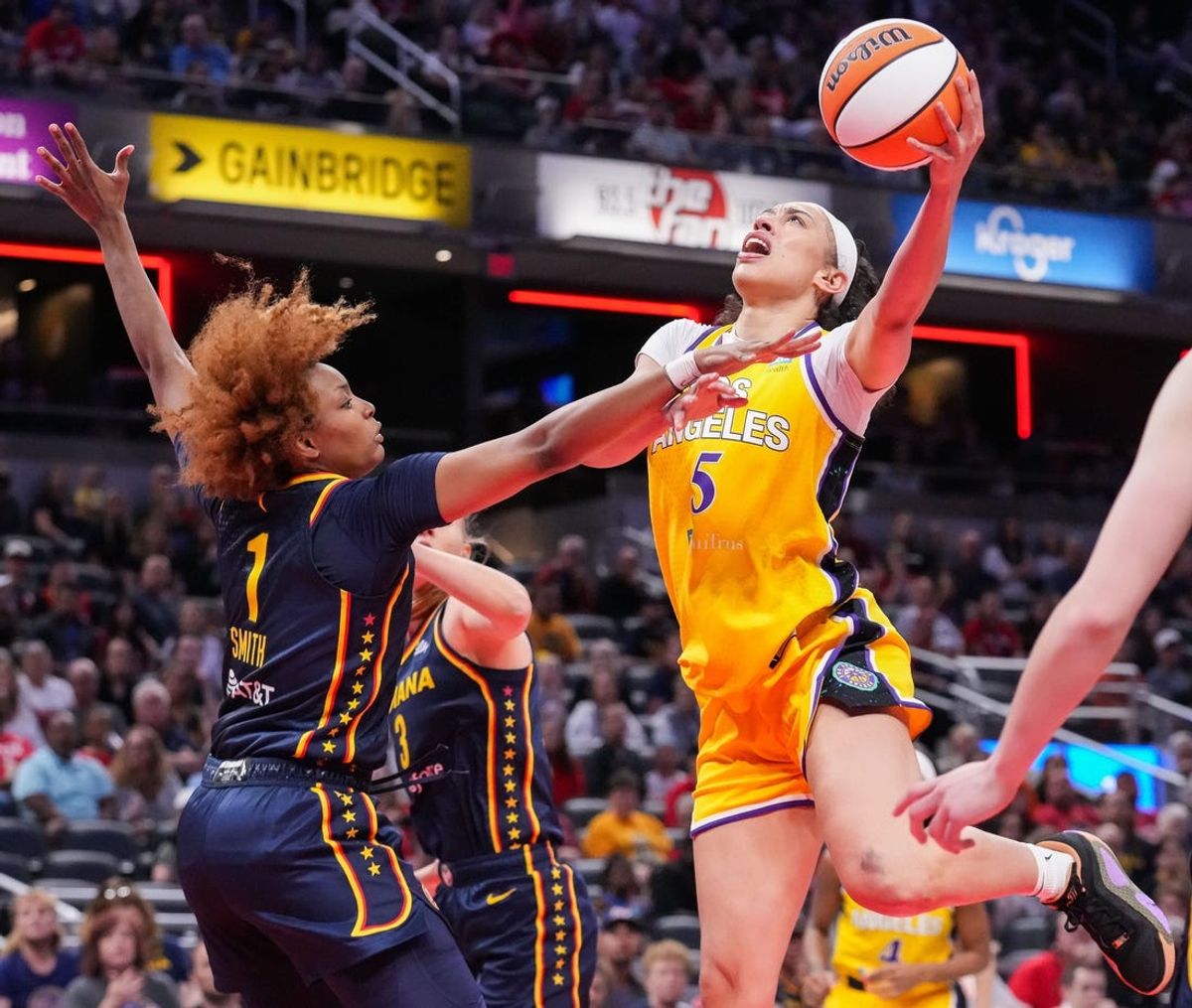 Los Angeles Sparks forward Dearica Hamby (5) goes in for a lay-up against Indiana Fever forward NaLyssa Smith (1) on Tuesday, May 28, 2024, during the game at Gainbridge Fieldhouse in Indianapolis.