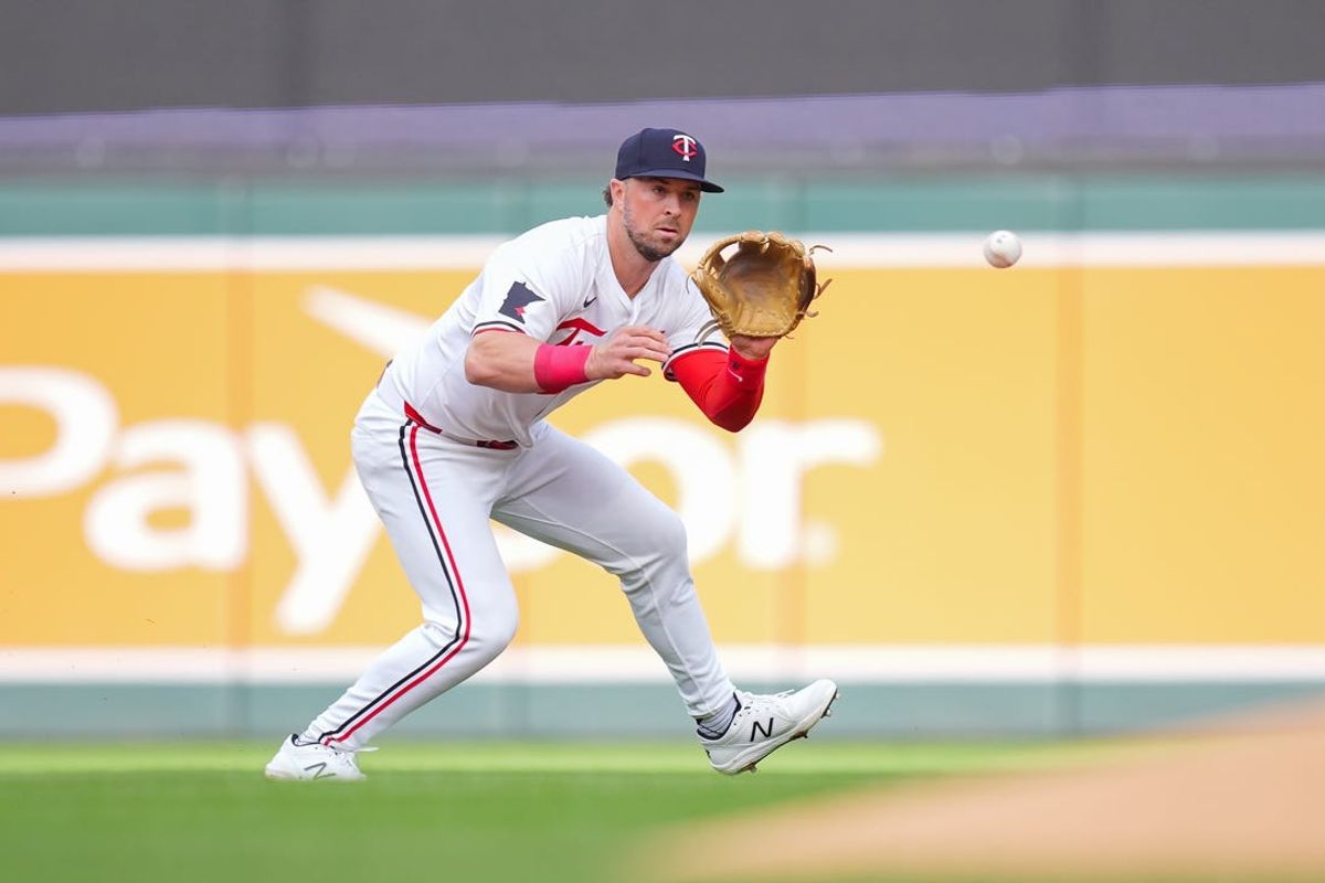 May 28, 2024; Minneapolis, Minnesota, USA; Minnesota Twins second base Kyle Farmer (12) fields a ground ball against the Kansas City Royals in the first inning at Target Field. Mandatory Credit: Brad Rempel-USA TODAY Sports