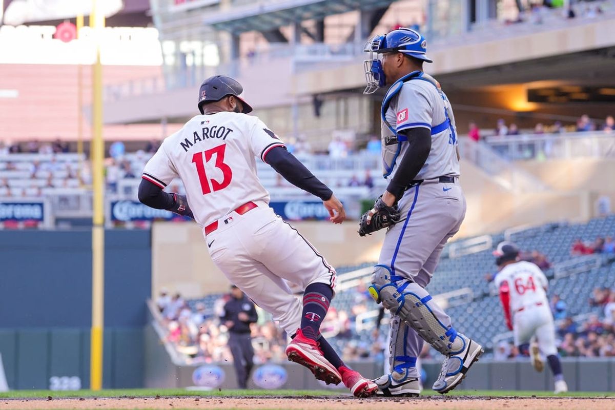 May 28, 2024; Minneapolis, Minnesota, USA; Minnesota Twins outfielder Manuel Margot (13) scores against the Kansas City Royals in the first inning at Target Field. Mandatory Credit: Brad Rempel-USA TODAY Sports