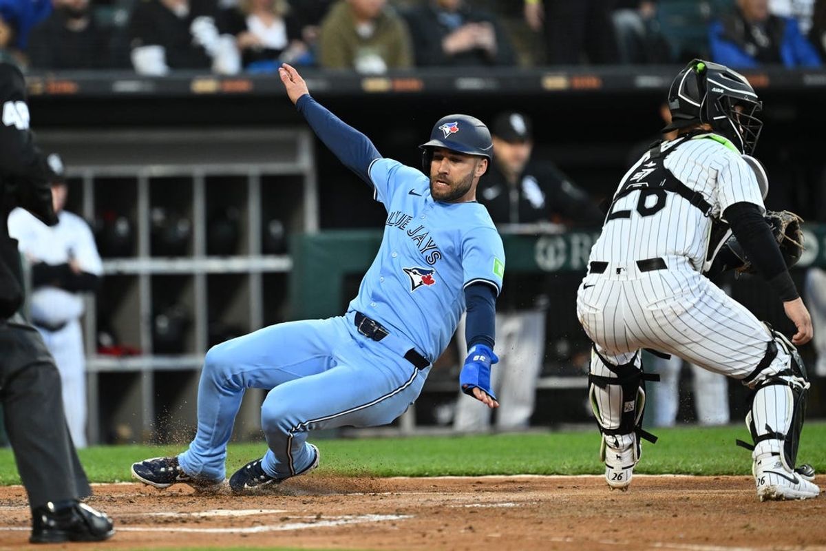 May 28, 2024; Chicago, Illinois, USA;  Toronto Blue Jays outfielder Kevin Kiermaier (39) slides home for a run in the second inning against the Chicago White Sox at Guaranteed Rate Field. Mandatory Credit: Jamie Sabau-USA TODAY Sports