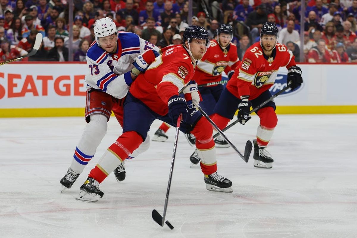 May 28, 2024; Sunrise, Florida, USA; Florida Panthers defenseman Niko Mikkola (77) protects the puck from New York Rangers center Matt Rempe (73) during the first period in game four of the Eastern Conference Final of the 2024 Stanley Cup Playoffs at Amerant Bank Arena. Mandatory Credit: Sam Navarro-USA TODAY Sports