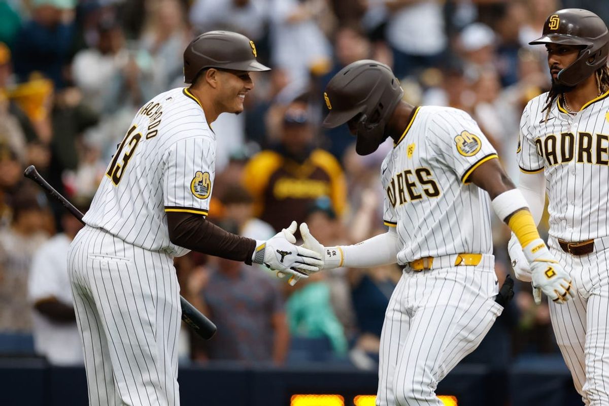 May 28, 2024; San Diego, California, USA; San Diego Padres left fielder Jurickson Profar (10) with San Diego Padres designated hitter Manny Machado (13) after hitting a two run home run in the first inning against the Miami Marlins  at Petco Park. Mandatory Credit: David Frerker-USA TODAY Sports