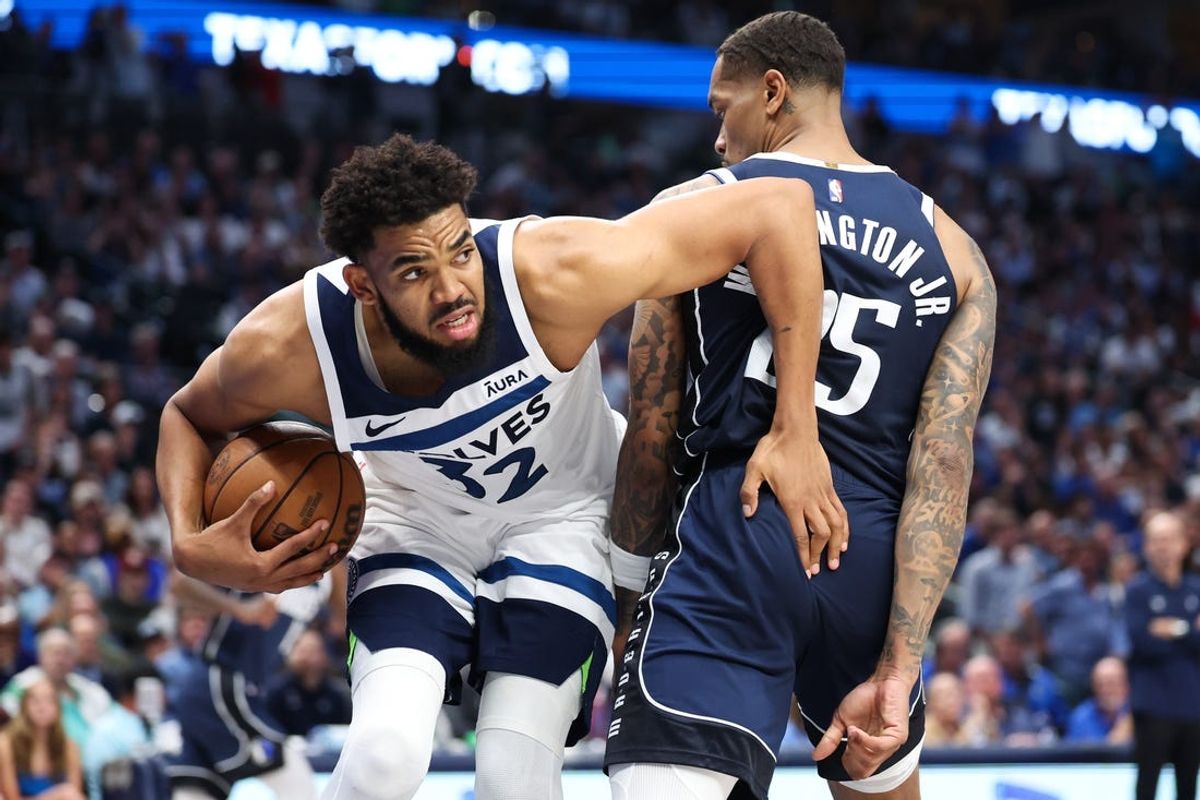 May 28, 2024; Dallas, Texas, USA; Minnesota Timberwolves center Karl-Anthony Towns (32) controls the ball against Dallas Mavericks forward P.J. Washington (25) during the third quarter of game four of the western conference finals for the 2024 NBA playoffs at American Airlines Center. Mandatory Credit: Kevin Jairaj-USA TODAY Sports