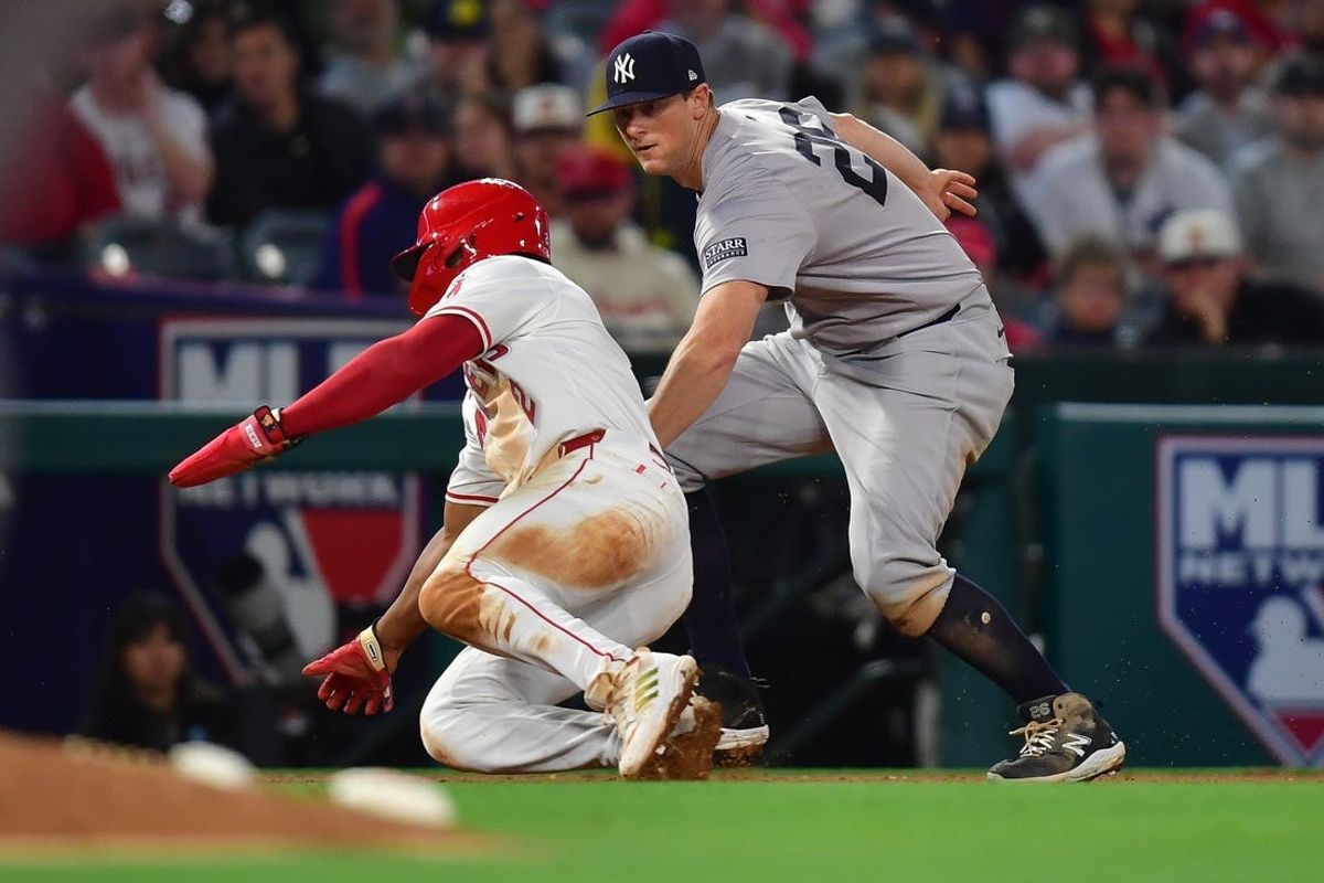 May 28, 2024; Anaheim, California, USA; New York Yankees third baseman DJ LeMahieu (26) tags Los Angeles Angels third baseman Luis Rengifo (2) during the sixth inning at Angel Stadium. Mandatory Credit: Gary A. Vasquez-USA TODAY Sports