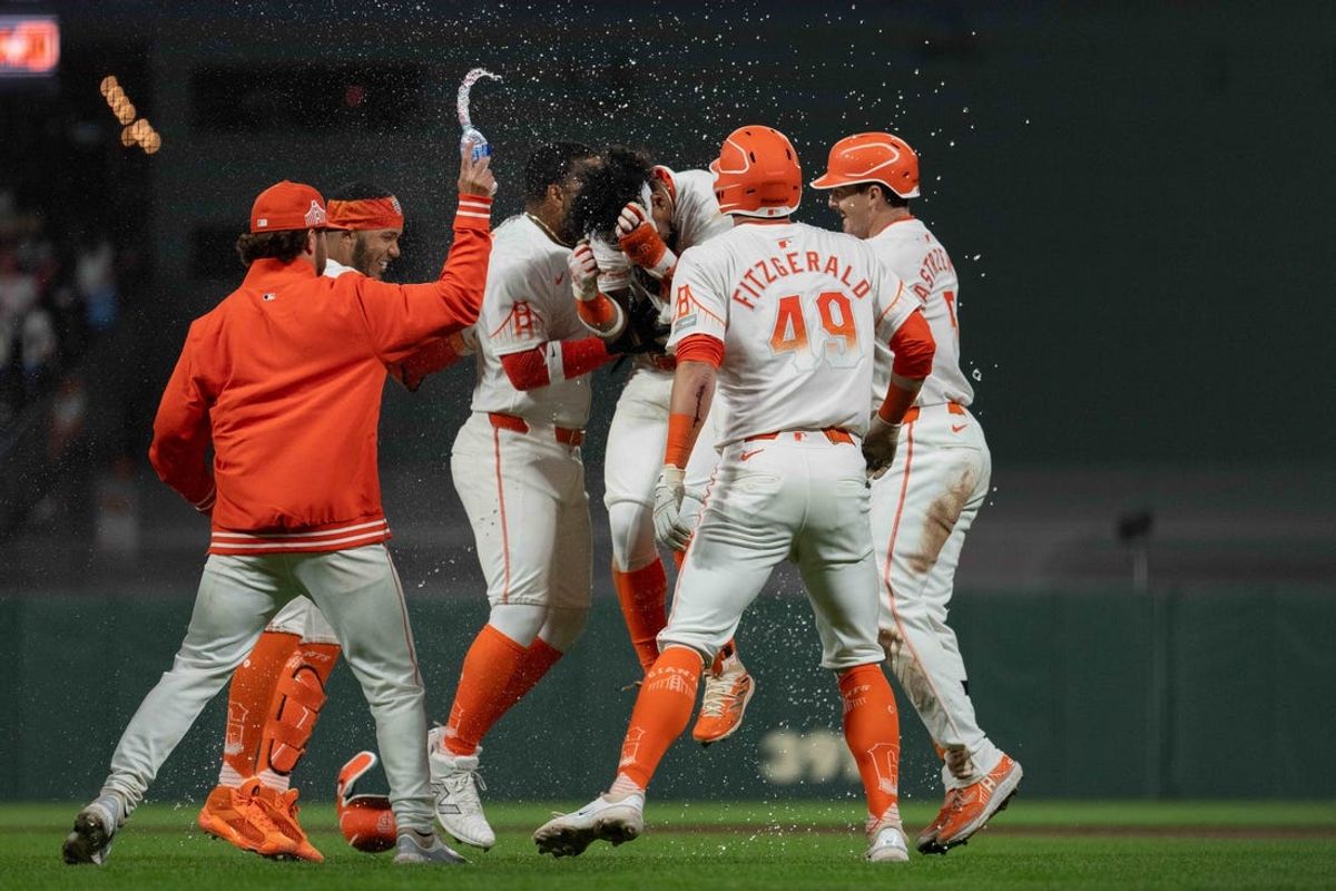 May 28, 2024; San Francisco, California, USA;  Teammates surround San Francisco Giants outfielder Luis Matos (29) after defeating the Philadelphia Phillies at Oracle Park. Mandatory Credit: Stan Szeto-USA TODAY Sports