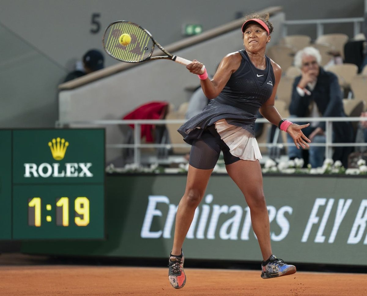 May 29, 2024; Paris, France; Naomi Osaka of Japan returns a shot during her match against Iga Swiatek of Poland on day four of Roland Garros at Stade Roland Garros. Mandatory Credit: Susan Mullane-USA TODAY Sports