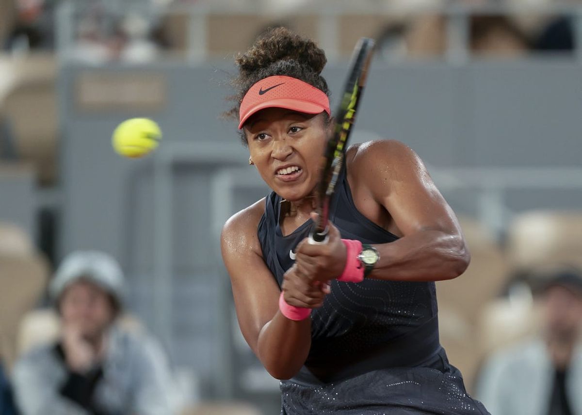 May 29, 2024; Paris, France; Naomi Osaka of Japan returns a shot during her match against Iga Swiatek of Poland on day four of Roland Garros at Stade Roland Garros. Mandatory Credit: Susan Mullane-USA TODAY Sports