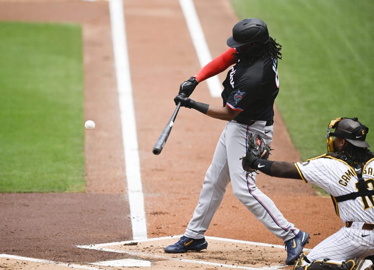 May 29, 2024; San Diego, California, USA; Miami Marlins first baseman Josh Bell (9) hits a single during the first inning against the San Diego Padres at Petco Park. Mandatory Credit: Denis Poroy-USA TODAY Sports