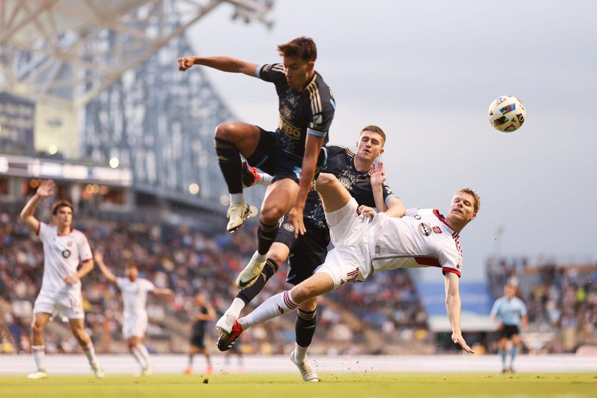 May 29, 2024; Philadelphia, Pennsylvania, USA; Toronto FC defender Sigurd Rosted (17) kicks the ball away from Philadelphia Union forward Mikael Uhre (7) and midfielder Quinn Sullivan (33) during the first half at Subaru Park. Mandatory Credit: Bill Streicher-USA TODAY Sports