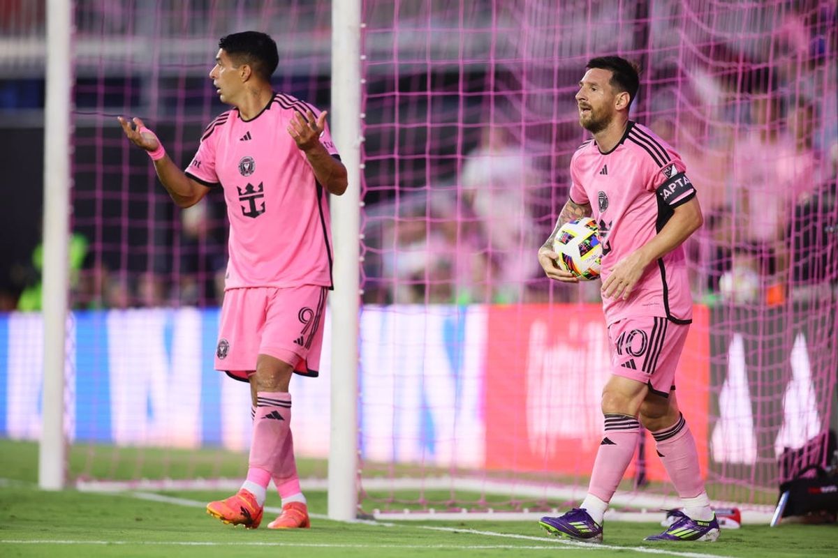 May 29, 2024; Fort Lauderdale, Florida, USA; Inter Miami CF forward Lionel Messi (10) retrieves the ball as forward Luis Suarez (9) reacts against Atlanta United during the first half at Chase Stadium. Mandatory Credit: Sam Navarro-USA TODAY Sports