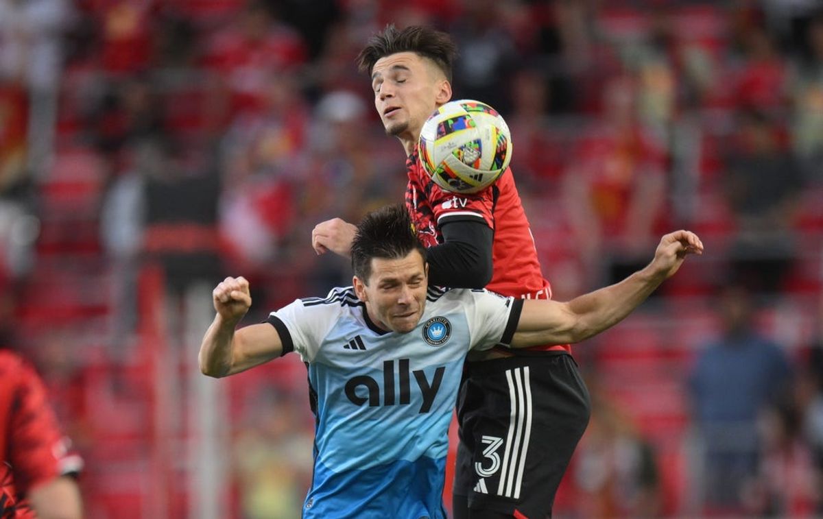 May 29, 2024; Harrison, New Jersey, USA; Charlotte FC midfielder Brandt Bronico (13) and New York Red Bulls defender Noah Eile (3) compete for a high ball during the first half at Red Bull Arena. Mandatory Credit: John Jones-USA TODAY Sports