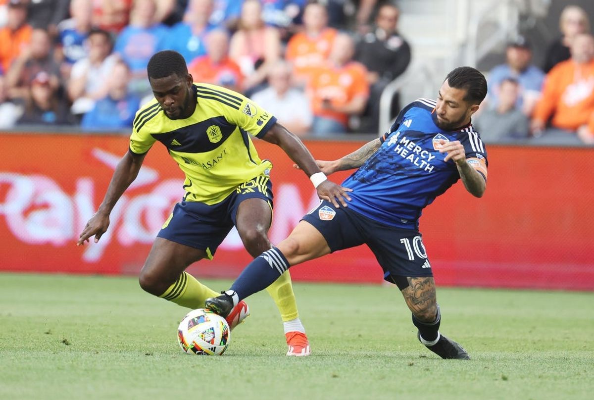 May 29, 2024; Cincinnati, Ohio, USA; FC Cincinnati midfielder Luciano Acosta (10) handles the ball while being guarded by Nashville SC midfielder Dru Yearwood (16) during their MLS soccer match at TQL Stadium. Mandatory Credit: Trevor Ruszkowski-USA TODAY Sports