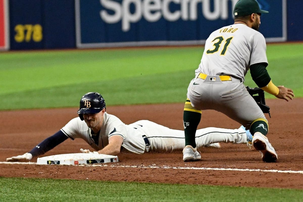 May 29, 2024; St. Petersburg, Florida, USA; Tampa Bay Rays second baseman Brandon Lowe (8) slides into third base with a RBI triple  in the fourth inning against the Oakland Athletics  at Tropicana Field. Mandatory Credit: Jonathan Dyer-USA TODAY Sports