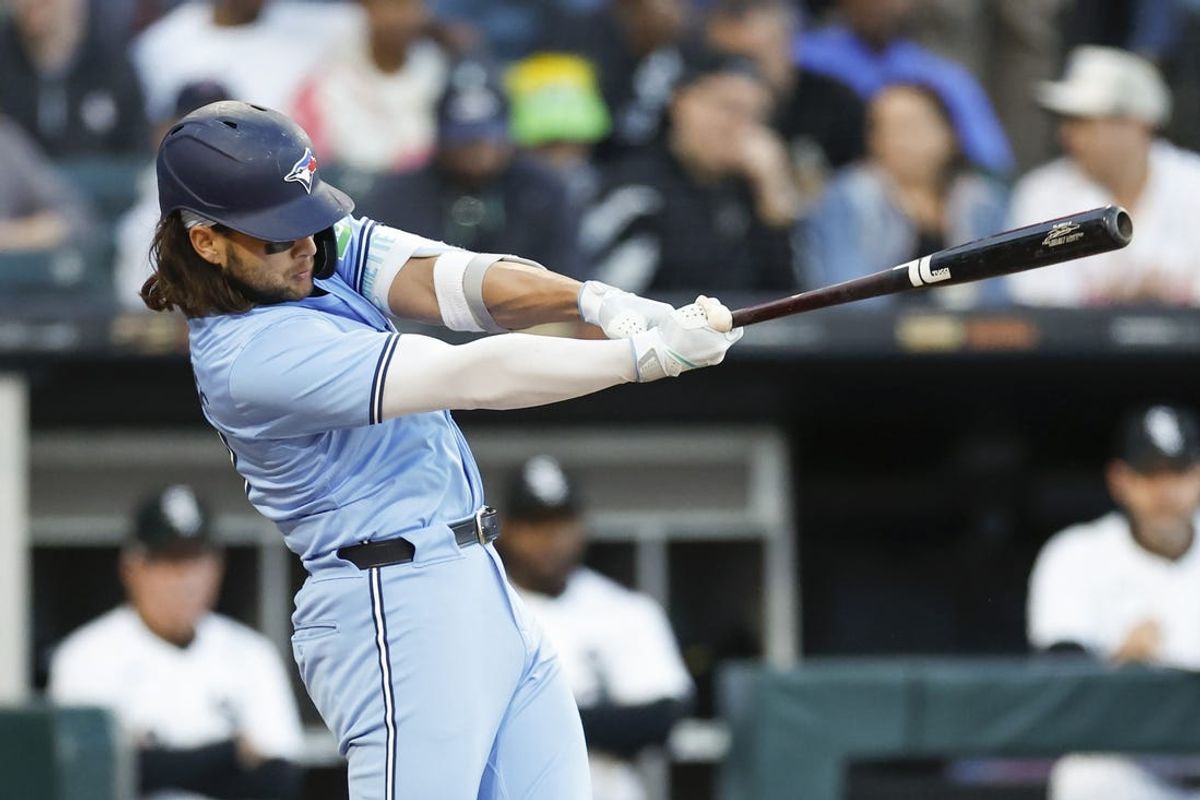 May 27, 2024; Chicago, Illinois, USA; Toronto Blue Jays shortstop Bo Bichette (11) hits an RBI-single against the Chicago White Sox during the third inning at Guaranteed Rate Field. Mandatory Credit: Kamil Krzaczynski-USA TODAY Sports