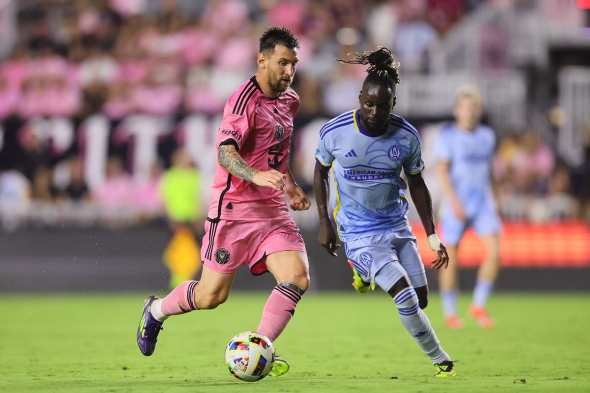 May 29, 2024; Fort Lauderdale, Florida, USA; Inter Miami CF forward Lionel Messi (10) dribbles against Atlanta United midfielder Tristan Muyumba (8) during the first half at Chase Stadium. Mandatory Credit: Sam Navarro-USA TODAY Sports
