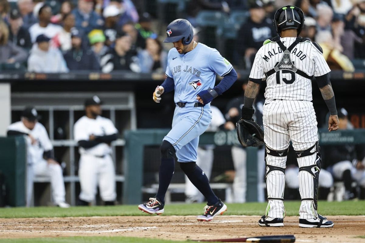 May 27, 2024; Chicago, Illinois, USA; Toronto Blue Jays outfielder George Springer (4) scores against the Chicago White Sox during the fourth inning at Guaranteed Rate Field. Mandatory Credit: Kamil Krzaczynski-USA TODAY Sports