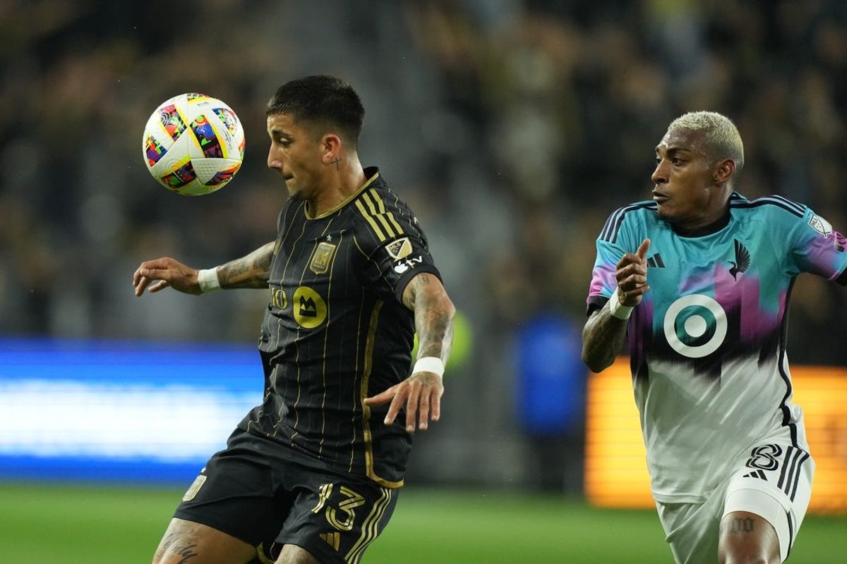 May 29, 2024; Los Angeles, California, USA; LAFC forward Cristian Olivera (13) controls the ball as Minnesota United forward Joseph Rosales (8) defends during the first half at BMO Stadium. Mandatory Credit: Kirby Lee-USA TODAY Sports