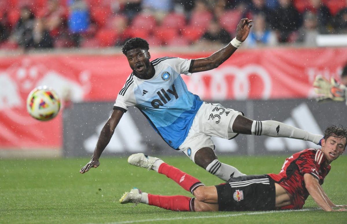 May 29, 2024; Harrison, New Jersey, USA; Charlotte FC forward Patrick Agyemang (33) and New York Red Bulls midfielder Daniel Edelman (75) battle for the ball in the second half at Red Bull Arena. Mandatory Credit: John Jones-USA TODAY Sports