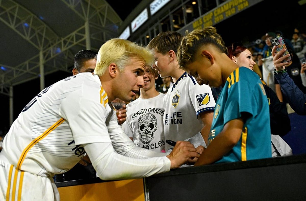 May 29, 2024; Carson, California, USA; LA Galaxy midfielder Riqui Puig signs an autograph for a fan after their win against FC Dallas at Dignity Health Sports Park. Mandatory Credit: Kelvin Kuo-USA TODAY Sports