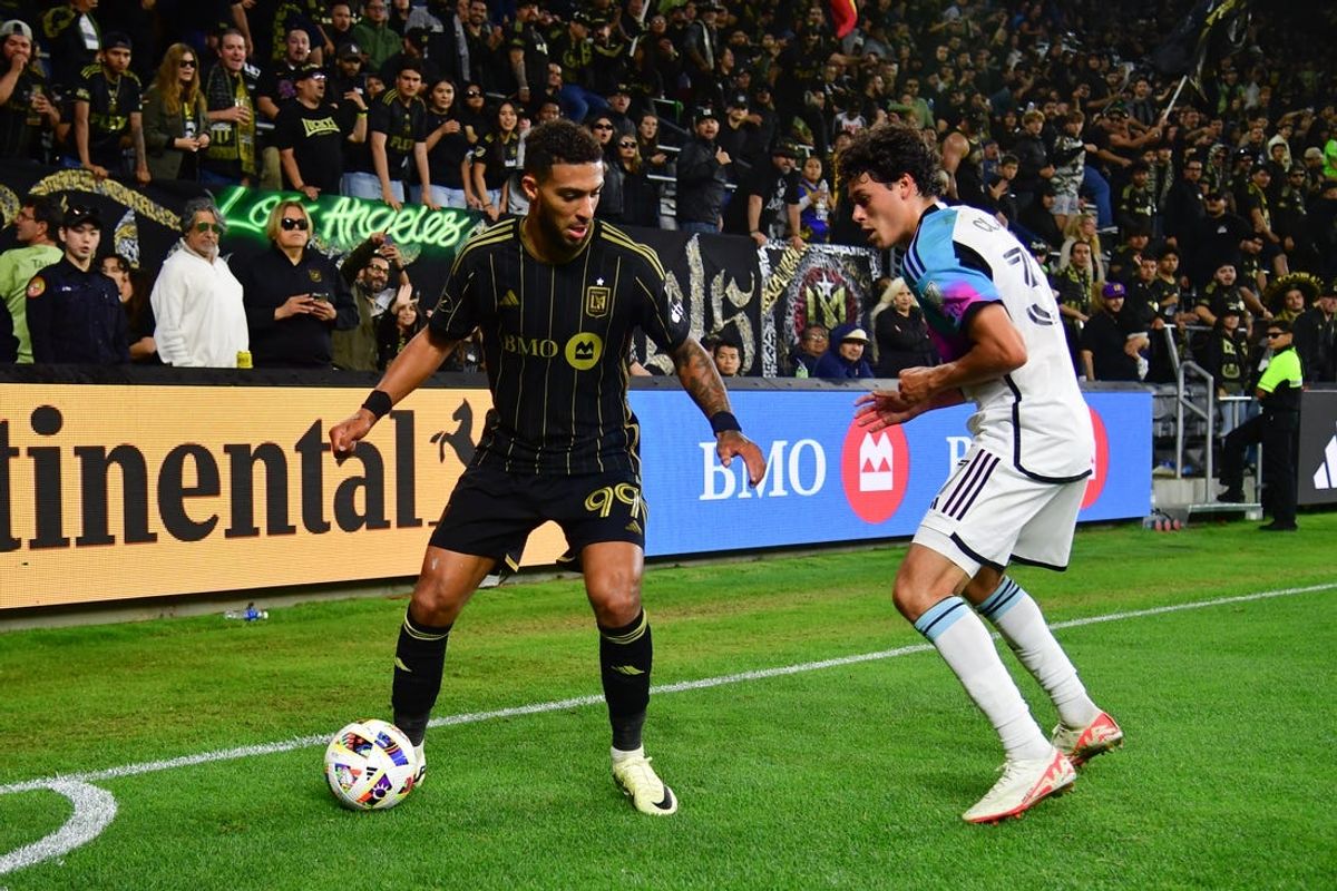 May 29, 2024; Los Angeles, California, USA; LAFC forward Denis Bouanga (99) dribbles against Minnesota United defender Caden Clark (37) during the second half at BMO Stadium. Mandatory Credit: Gary A. Vasquez-USA TODAY Sports