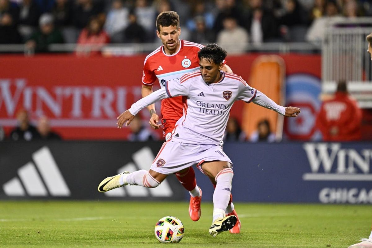May 29, 2024; Chicago, Illinois, USA;  Orlando City SC midfielder Facundo Torres (10) controls the ball in front of Chicago Fire FC midfielder Gaston Gimenez (30) in the second half at Soldier Field. Mandatory Credit: Jamie Sabau-USA TODAY Sports