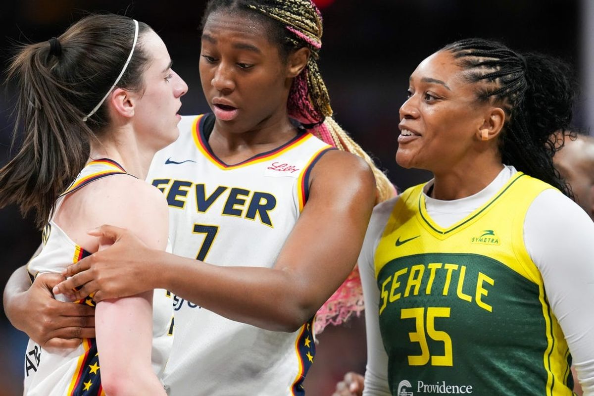 Indiana Fever guard Caitlin Clark (22) talks to Seattle Storm guard Victoria Vivians (35) following being run into after making a three-pointer, Thursday, May 30, 2024, during the WNBA game at Gainbridge Fieldhouse in Indianapolis.
