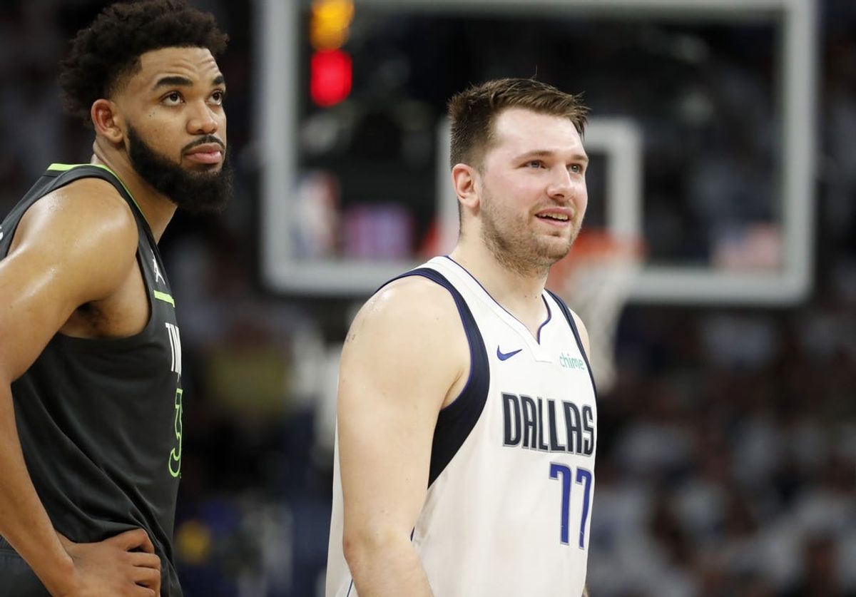 May 30, 2024; Minneapolis, Minnesota, USA; Minnesota Timberwolves center Karl-Anthony Towns (32) and Dallas Mavericks guard Luka Doncic (77) during the second quarter in game five of the western conference finals for the 2024 NBA playoffs at Target Center. Mandatory Credit: Bruce Kluckhohn-USA TODAY Sports
